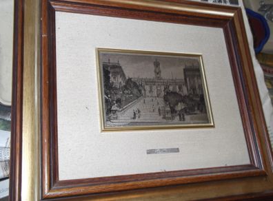 a picture with a silver plaque in the centre