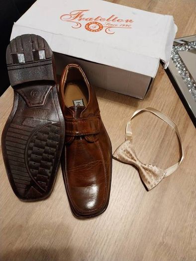 As new in box size 4 brown leather with bow tie also