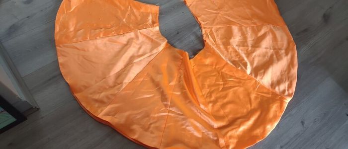 Solid orange satin look piece of fabric with beads