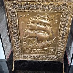 Vintage brass fireplace screen with ship design