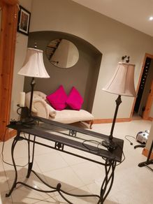 Console table with two matching lamps.