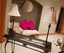 Console table with two matching lamps.