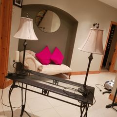 Console table with two matching lamps.