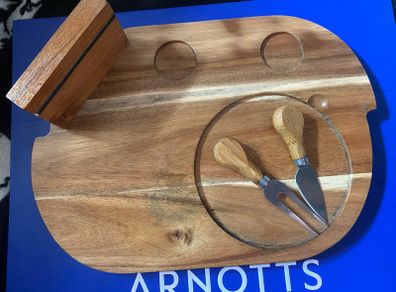 wooden cheese platter with fork and knife