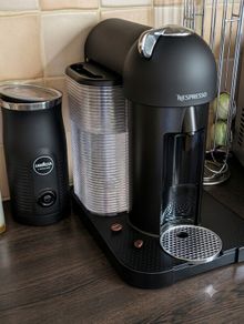 Nespresso coffee machine with lavazza frother and coffee pod stand