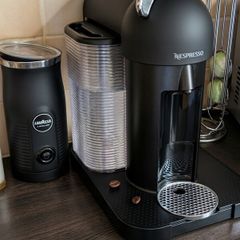 Nespresso coffee machine with lavazza frother and coffee pod stand