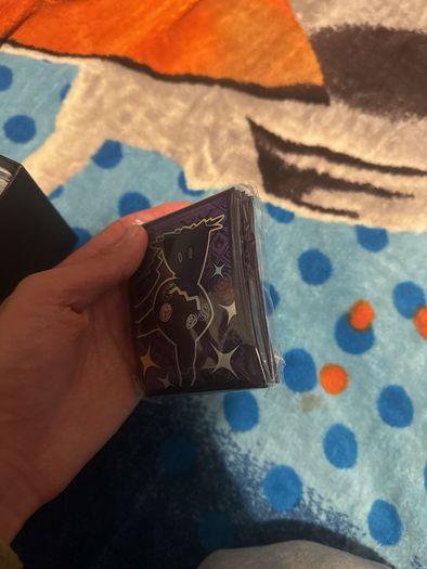 pokemon cards and book and sleeves and game thing