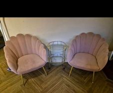 Two pink velvet shell chairs