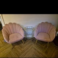Two pink velvet shell chairs