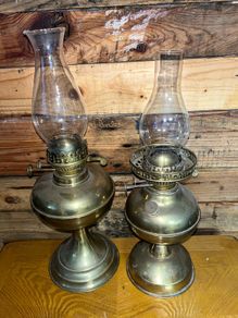 Two antique brass oils lamps