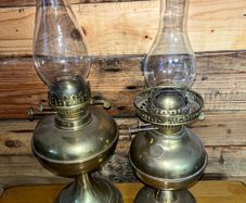 Two antique brass oils lamps