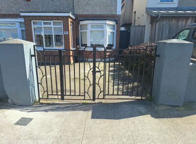 Black wrought iron mdtal double garden gates