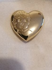 the variety club child's face brooch.