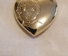 the variety club child's face brooch.
