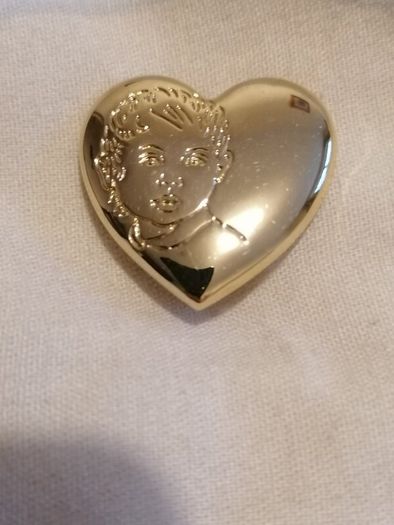 the variety club child's face brooch.