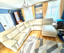 Leather sofa with two reclining electric powered sections