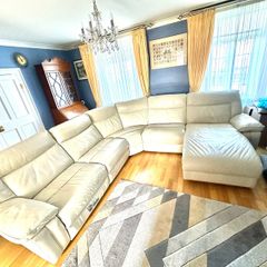 Leather sofa with two reclining electric powered sections