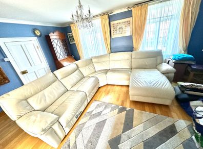 Leather sofa with two reclining electric powered sections