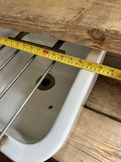 Heavy vintage ceramic basin with a built-in metal rack.