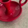 3 different itmes- 1- pottery modern design handmade candle holder 18.00 euro. 2-  red enamel candlestick holder and drip tray featuring a Considered by Helen James 12.00 euro. 3-  PAPERWEIGHT 15.00 euro Image 9