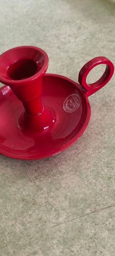 3 different itmes- 1- pottery modern design handmade candle holder 18.00 euro. 2-  red enamel candlestick holder and drip tray featuring a Considered by Helen James 12.00 euro. 3-  PAPERWEIGHT 15.00 euro