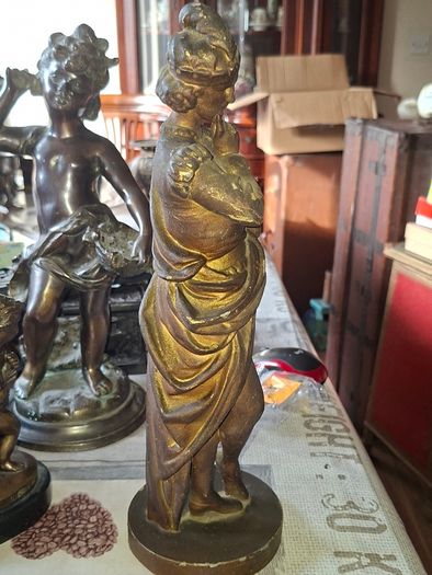 Antique Sculpture a gilt-bronze cast-metal Spanish Conquistador. On his torso is a Cross Pattee, a historical motif commonly associated with Christian military orders and medieval heraldry