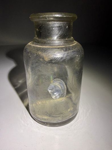 Old clear small glass jar