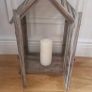 Rustic house-shaped wooden lantern featuring glass panel doors and a pitched roof design Image 3