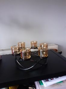 Round wrough iron with 6  thick  glasses for csndles or tea light candles 15 euro         glassas