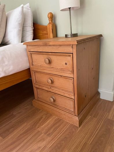 Solid antique pine three-drawer bedside locker
