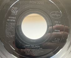 Bon Jovi. Keep The Faith. Seven inch jukebox large hole single. Etched label and backed with I wish every day could be like Christmas. Plays great. No cover.