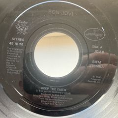 Bon Jovi. Keep The Faith. Seven inch jukebox large hole single. Etched label and backed with I wish every day could be like Christmas. Plays great. No cover.