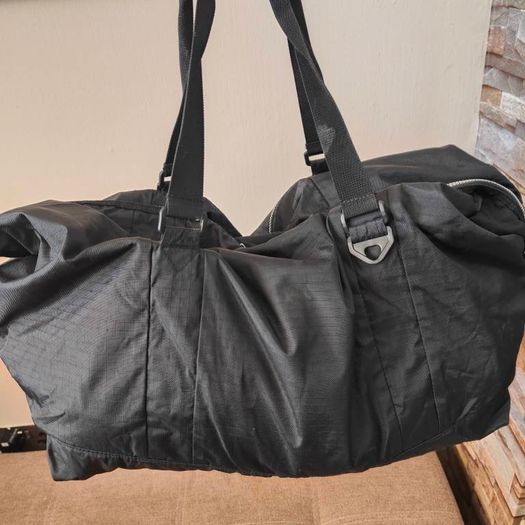 Large black expandable travel bag with shoulder strap