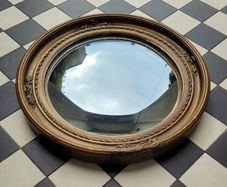 Antique gilt wood floral motif convex mirror