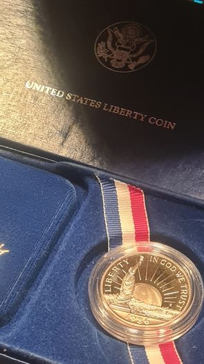 American 1986s silver dollar. Ellis Island
