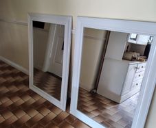 2 White framed mirrors