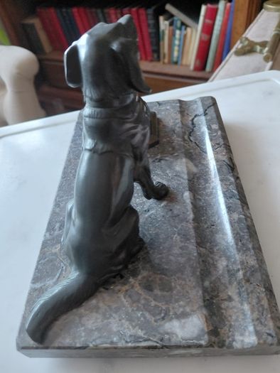 Antique desk inkwell with a seated dog on marble stand