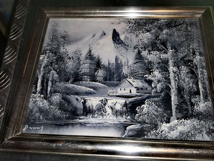 Black and white oil painting in silver frame