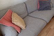 Two-seater grey fabric sofa