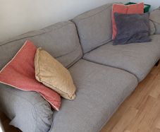 Two-seater grey fabric sofa