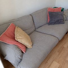Two-seater grey fabric sofa