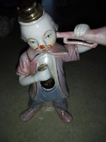 old porcelain figurine of clown.
