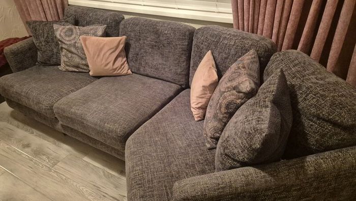 Grey corner couch with 6 matching cushions