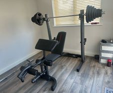 Home Gym Equipment: Adjustable Weider Gym Bench, Olympic bars, and Rubber Weights
