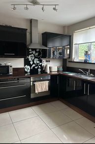 Black high gloss kitchen units and countertop