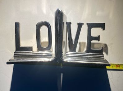 bookends made of cast metal likely aluminum that spell love