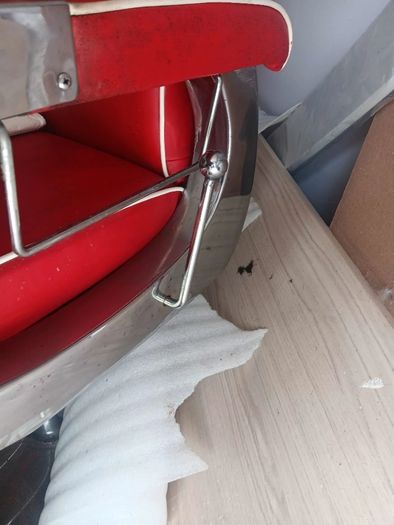 Beautiful red vintage Barbers chair with white piping