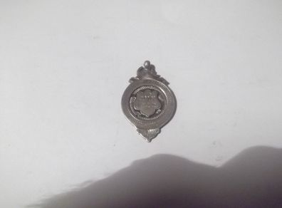 a solid silver medal on it c,m,w  fcc