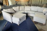 Large grey corner sofa with 2 footstools