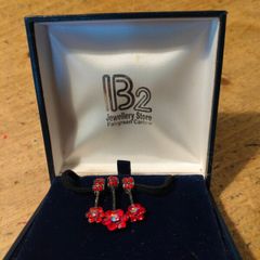 red poppy flower design Necklace  sold by independent jewelers like IB2 Jewellery Store. New in box.
